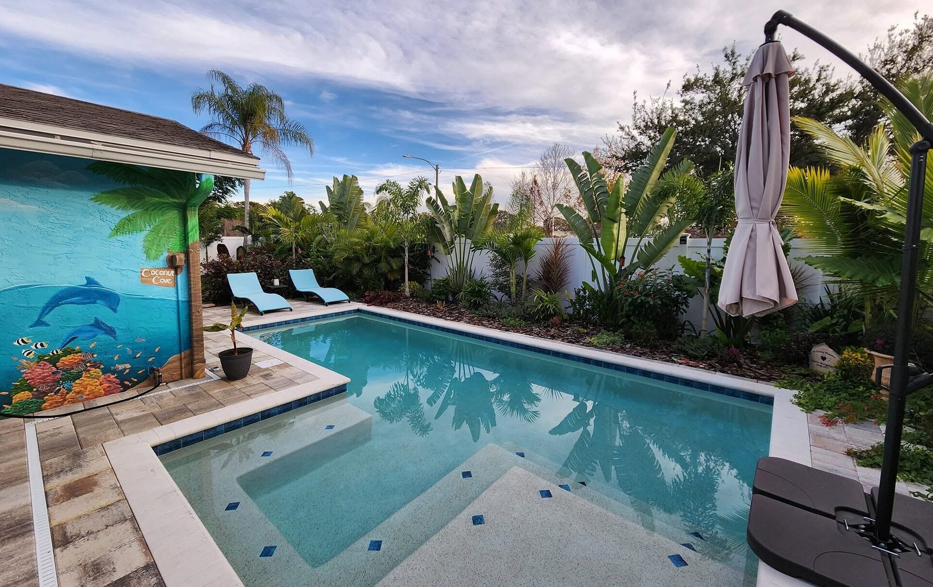 A welcoming Coconut Cove poolside garden in St. Petersburg with layered tropical planting